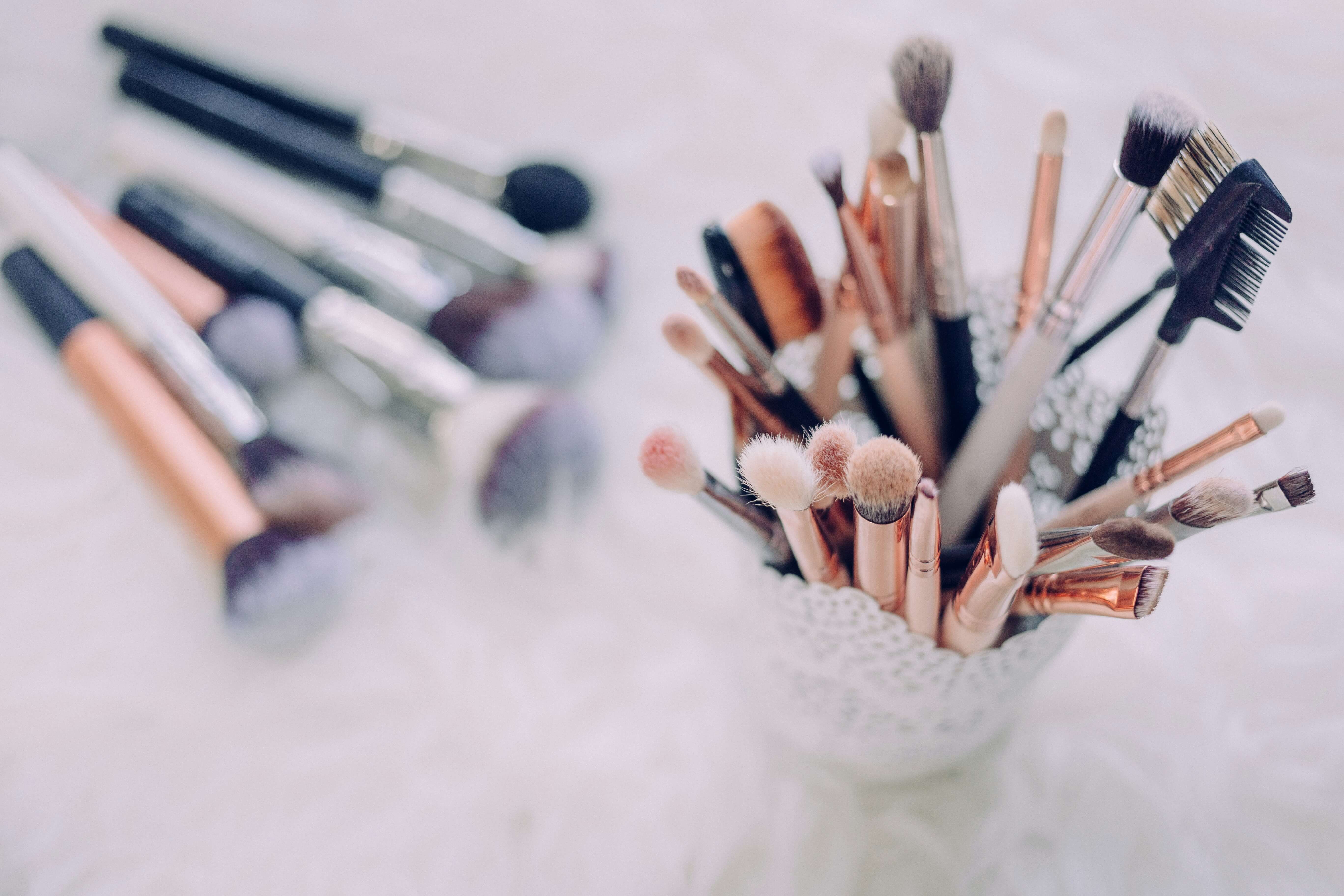 A collection of makeup brushes and tools of varying sizes