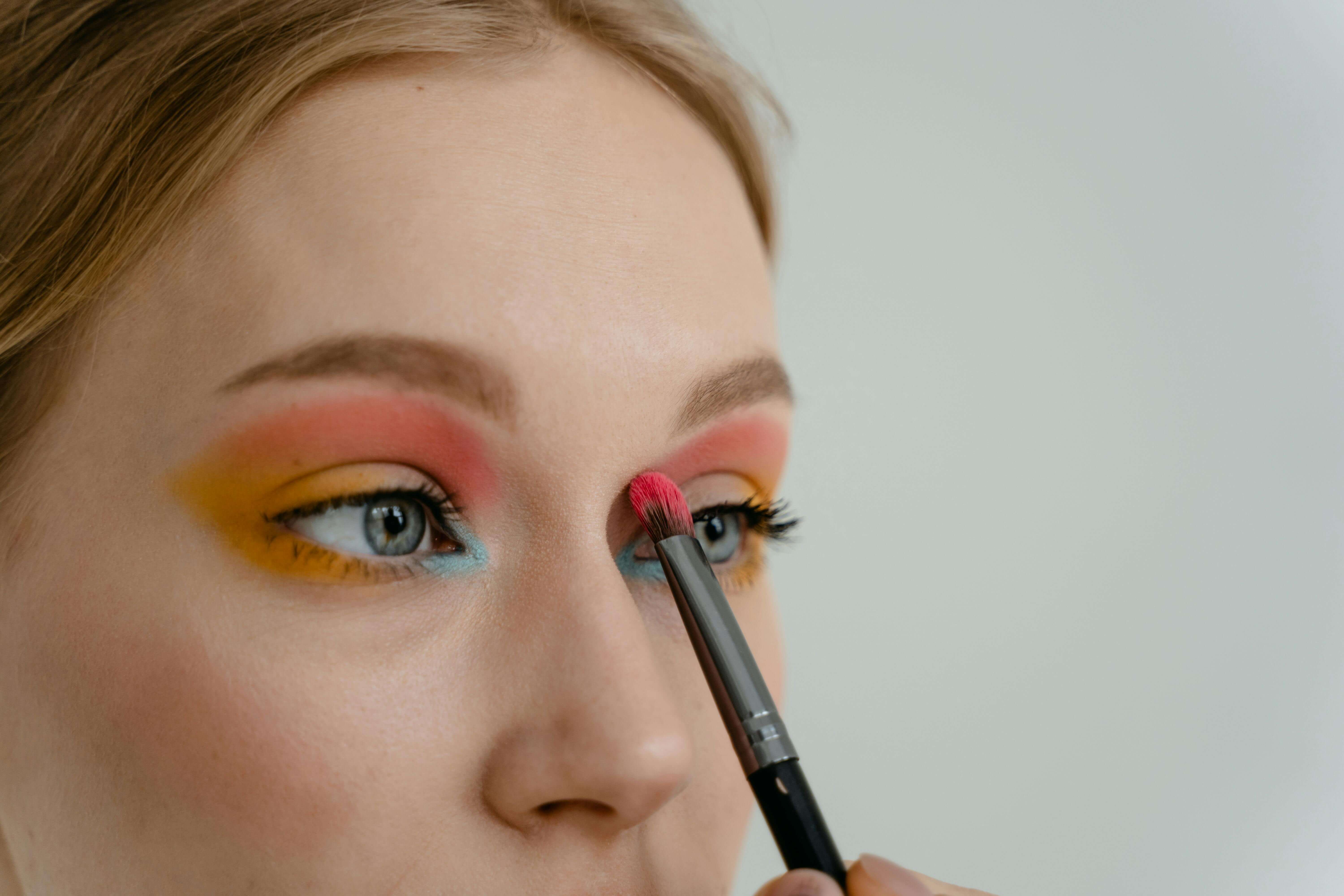 Woman applying a colorful, pigmented eyeshadow look